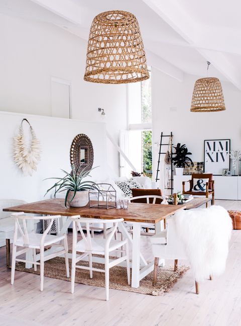 light and airy dining room with rustic boho feel. White chairs .