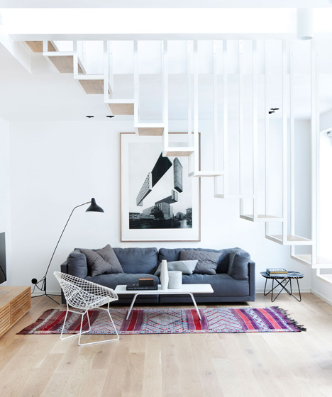 Floating steel staircase divides Idunsgate Apartment by Hapt