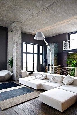 Raw cement look giving this living area an industrial feel. www .