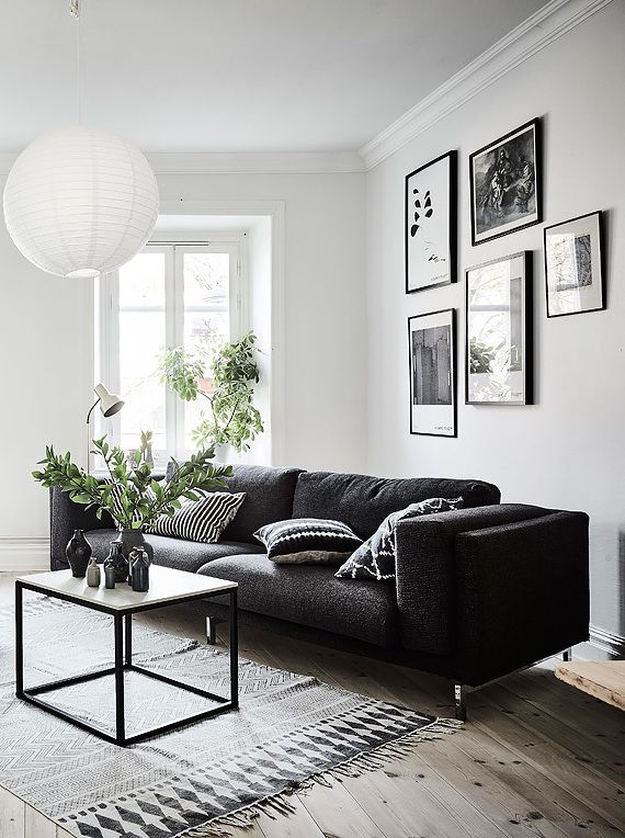 Living room in black, white and gray with nice Gallery wall .