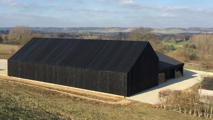 Black barn built by Macdonald Wright at Caring Wood country house .