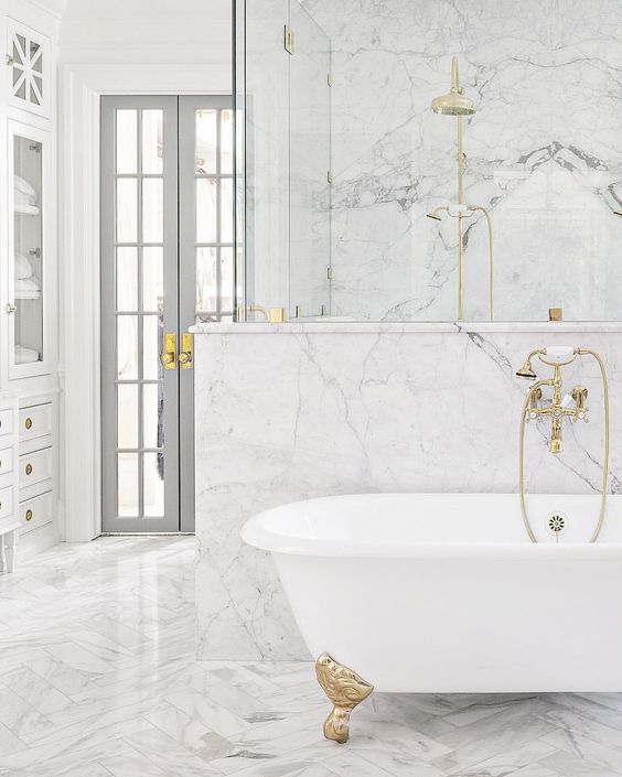 Choose marble walls and floors for your white bathroom to create a .