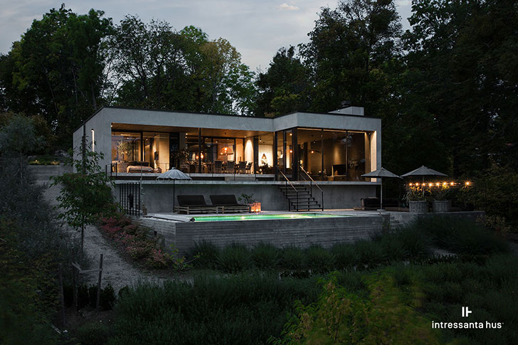 Contemporary lake house of concrete with a swimming pool .