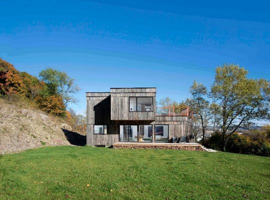 Into the Wild House is Clad in Weathered Wood with Accent on the .