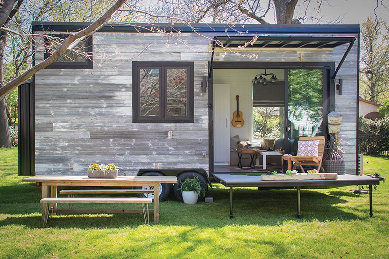 Tiny House — weathered wood exterior, built on a trailer platform .