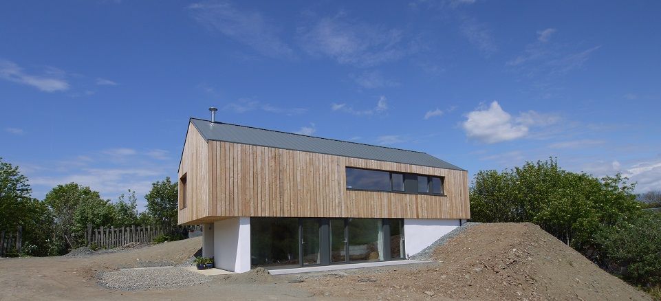 Vertical larch cladding on the upper floor and white render on the .