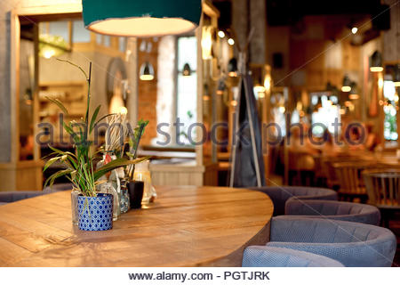 Modern loft style cafe interior in warm colors Stock Photo - Ala