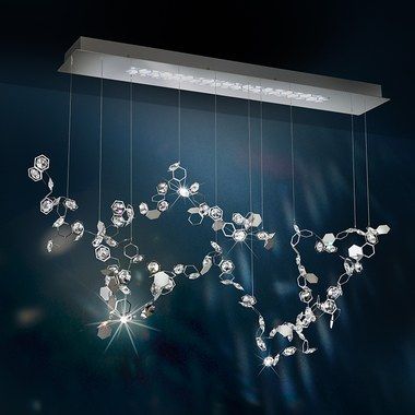 Fluttering crystal constellations hang from a geometric ceiling .