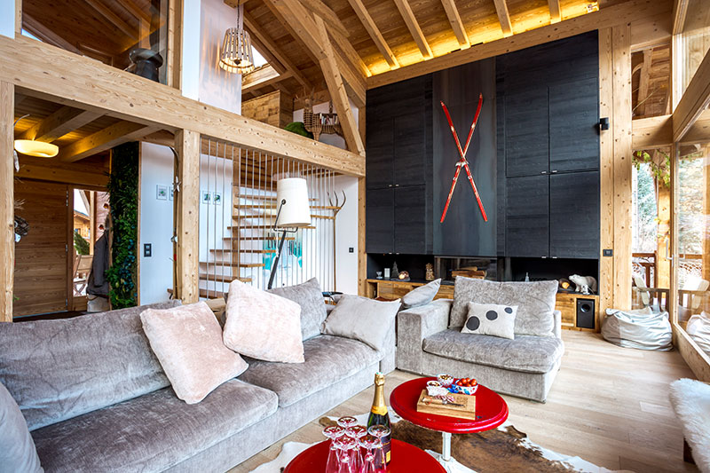 Chic modern chalet with red skis as decor and panoramic window in .
