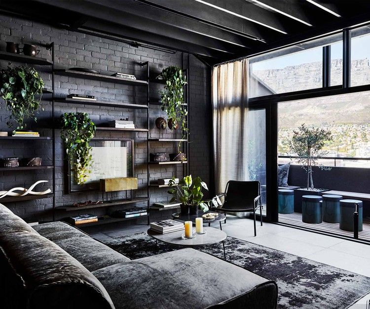 An industrial-style apartment with a dark and moody monochrome .