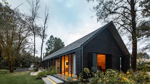 A Long and Narrow Cabin House With A Beautiful Burnt Wood Exterior .