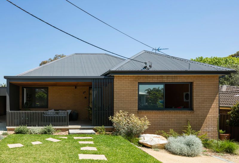 A Black Rear Extension Was Added To A 1960's Brick House In Sydney .