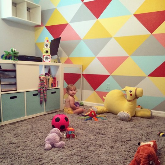 Small And Bold Kids Playroom Design With A Bold Geo Wall - DigsDi