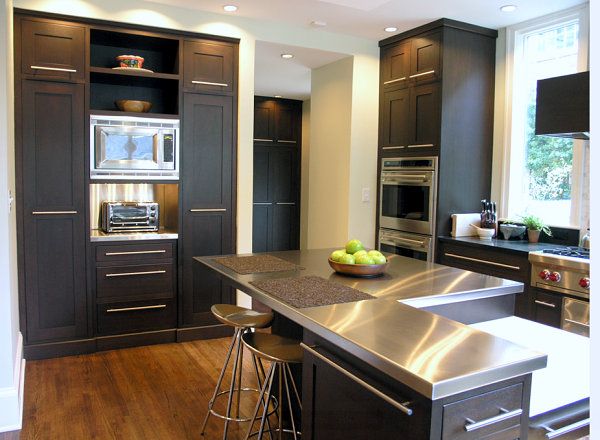 Stainless steel countertops brighten a kitchen with black .