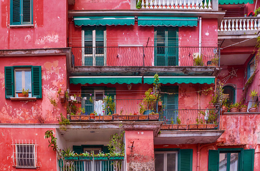 Street View Of Brightly Colored Artistically Painted Old Apartment .
