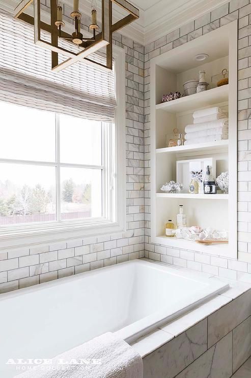 Bathtub nook completed with a built-in shelf surrounding Calcutta .