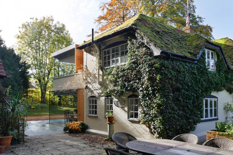 Historical English Cottage With A Cantilevered Glazed Extension .