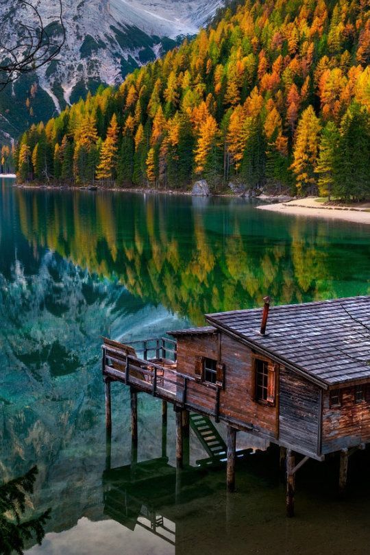 Beautiful Lake house view with the autumn trees and mountains .