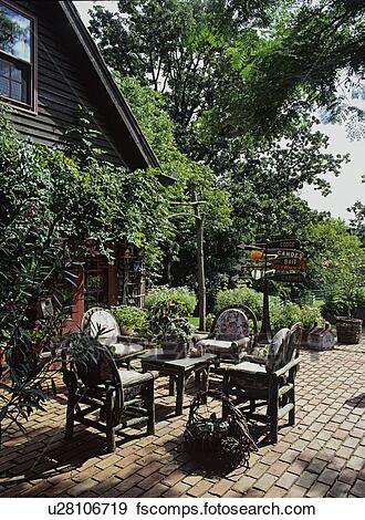 Patios: Brick patio with twig table and chairs with cushions, off .