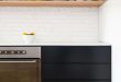 Minimal Black And White Kitchen With A White Brick Wall - DigsDi