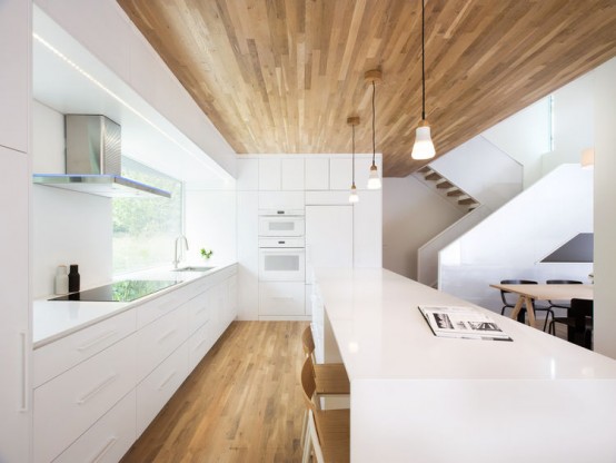Minimalist Home With Oak-Surfaced Interiors On A Tricky Site .