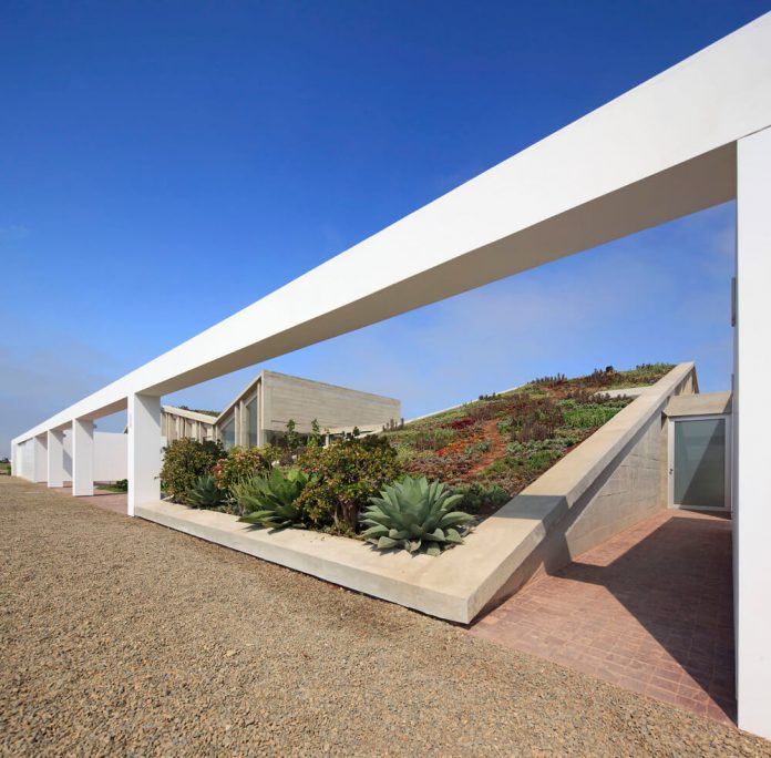 L” shaped house on desert hills, an extension of the Andes .