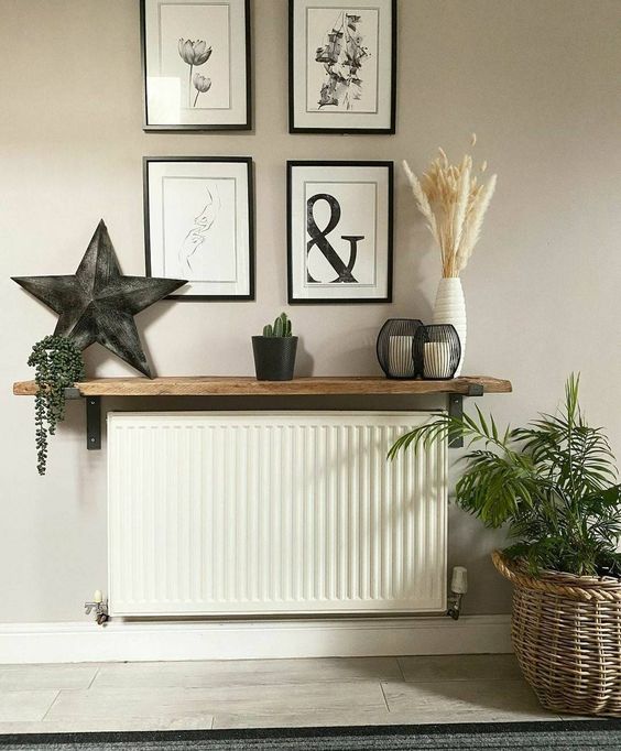 a little shelf installed over the radiator becomes a cool console table for a small entryway, it looks very cohesive