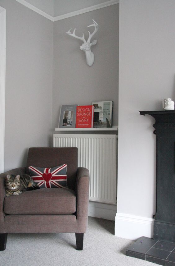 a picture ledge over the radiator to hold magazines and books is a smart way to use this small space to advantage