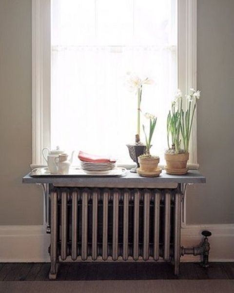 a shelf placed on the radiator and used as a window sill is a small yet helpful storage unit, and you can make it yourself