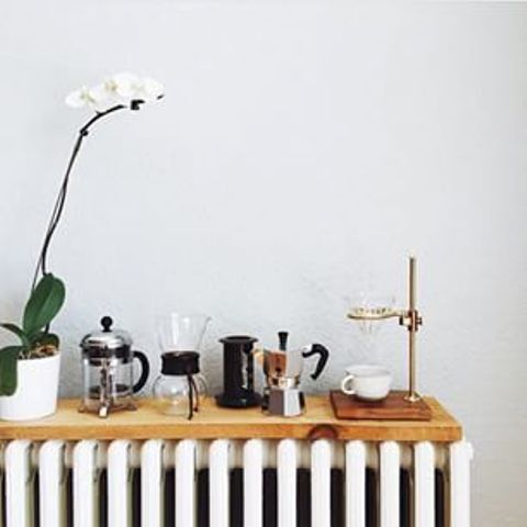 a wooden shelf on the radiator used for tea supplies in the kitchen is a lovely additional shelf for any space