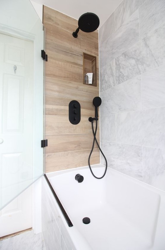 marble can be paired with wood-like tiles to create a chic and luxurious space, add black fixtures for a modern feel
