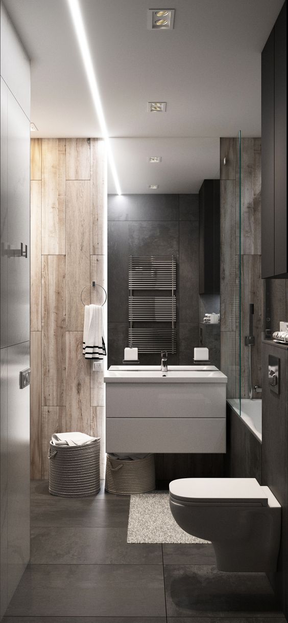 a minimalist bathroom with wood look tiles of two different shades and stone like tiles on the floor