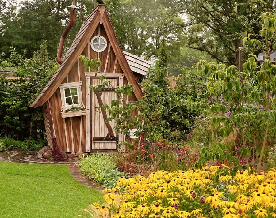 small garden shed in the shape of a house, large garden 
