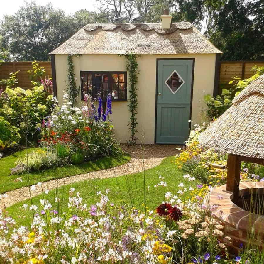small garden shed that is reminiscent of a house 