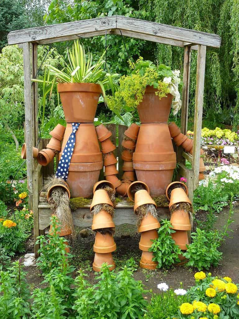 Terracotta pots that resemble people in the backyard 