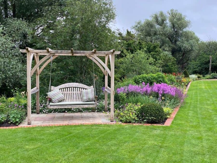 small wooden pavilion, hanging swing seat, large lawn