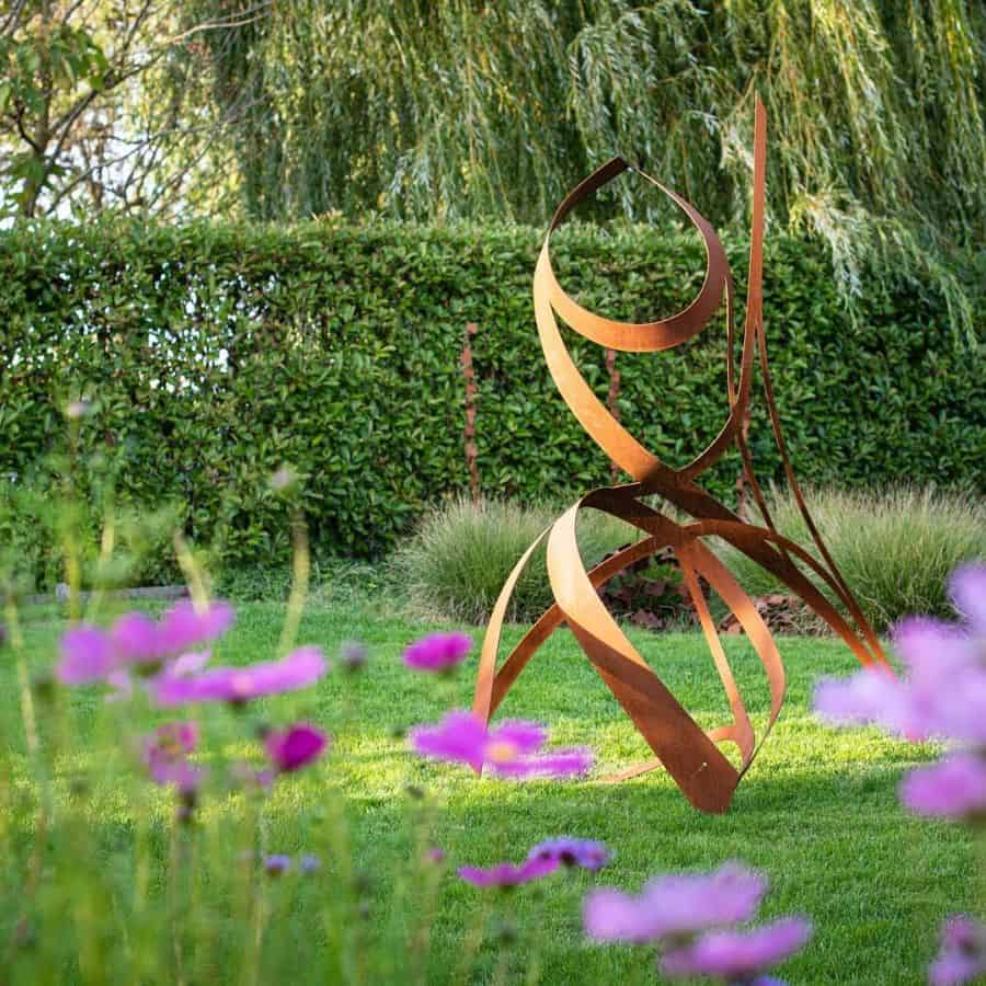 abstract copper art backyard garden purple flowers 
