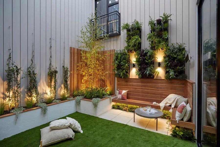 modern garden bench with white tiles, patio, wood, artificial grass, vertical wall planters 